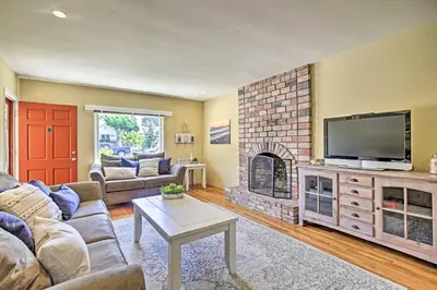 a living room with a fireplace and a tv at Oceanside Home with Yard - Walk to Beach and Pier in Oceanside