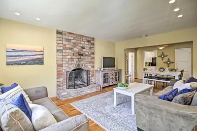 a living room with a couch and a fireplace at Oceanside Home with Yard - Walk to Beach and Pier in Oceanside