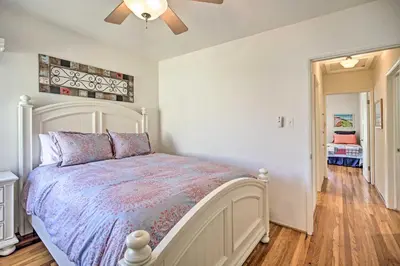 a bedroom with a bed and a ceiling fan at Oceanside Home with Yard - Walk to Beach and Pier in Oceanside