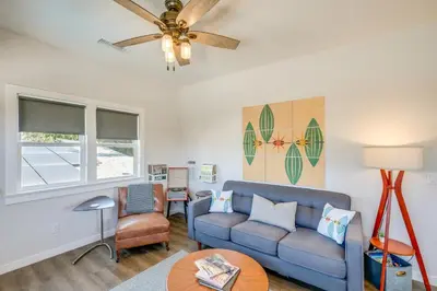 a living room with a couch and a ceiling fan at San Diego Guest House Apartment with Patio and Hot Tub in San Diego
