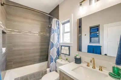 a bathroom with a sink and a toilet and a mirror at San Diego Guest House Apartment with Patio and Hot Tub in San Diego
