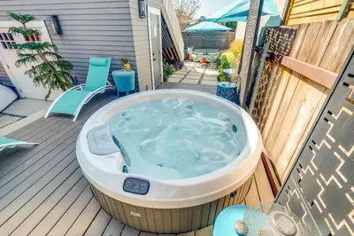 a jacuzzi tub on a deck with a chair at San Diego Guest House Apartment with Patio and Hot Tub in San Diego