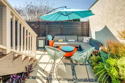 a patio with a couch and an umbrella at San Diego Guest House Apartment with Patio and Hot Tub in San Diego