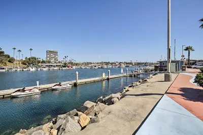 a marina with boats in the water and a dock at Beachfront Oceanside Condo with Pool and Hot Tub! in Oceanside