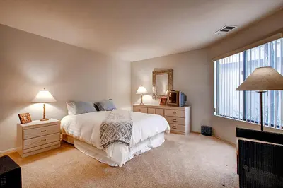 a bedroom with a bed and two lamps and a mirror at Borrego Springs Hideaway Pool Table, Mtn Views! in Borrego Springs