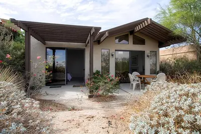 a small house with a patio with a table and chairs at Borrego Springs Hideaway Pool Table, Mtn Views! in Borrego Springs