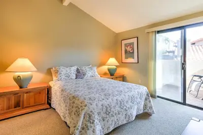 a bedroom with a bed and two lamps and a window at Borrego Springs Condo with Private Hot Tub and Views! in Borrego Springs