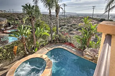a swimming pool in a resort with palm trees at Ocean-View San Diego Home with Pool, Patio and Hot Tub in San Diego