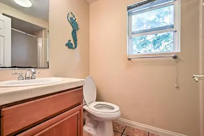 a bathroom with a toilet and a sink and a window at Ocean-View San Diego Home with Pool, Patio and Hot Tub in San Diego