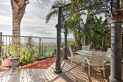 a patio with a table and chairs and a fence at Ocean-View San Diego Home with Pool, Patio and Hot Tub in San Diego