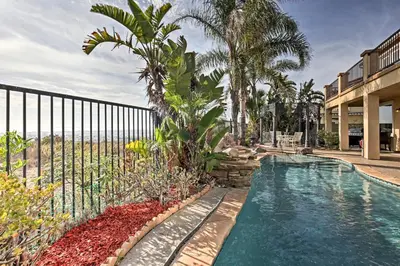 a swimming pool with palm trees and a fence at Ocean-View San Diego Home with Pool, Patio and Hot Tub in San Diego