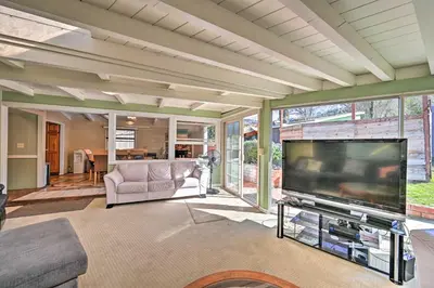 a living room with a large flat screen tv at La Jolla Home and Detached Suite Hot Tub and Backyard in San Diego