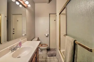 a bathroom with a sink and a toilet and a mirror at La Jolla Home and Detached Suite Hot Tub and Backyard in San Diego