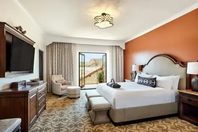 a hotel room with a large bed and a television at Inn at the Mission San Juan Capistrano, Autograph Collection in San Juan Capistrano