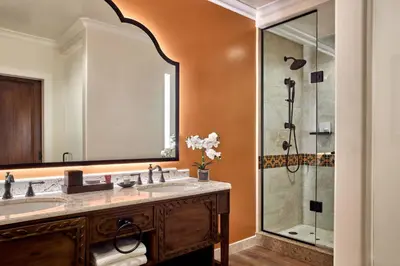 a bathroom with two sinks and a shower at Inn at the Mission San Juan Capistrano, Autograph Collection in San Juan Capistrano