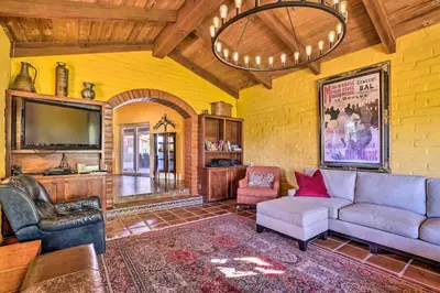 a living room with a couch and a tv at Equestrian Estate with Horse Stables and Pool! in Valley Center