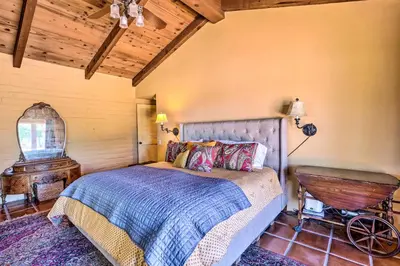 a bedroom with a bed and a wooden ceiling at Equestrian Estate with Horse Stables and Pool! in Valley Center
