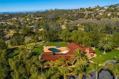 an aerial view of a house with a golf estate at Equestrian Estate with Horse Stables and Pool! in Valley Center