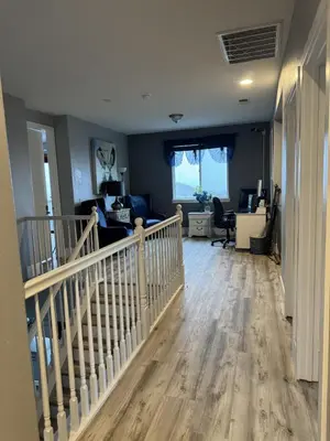 a room with a staircase and a living room at Beautiful City Lights and Mountain Views in Menifee