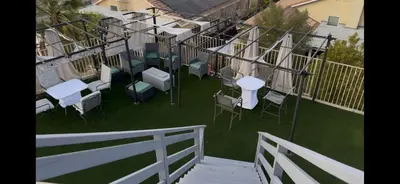 a balcony with chairs and tables on the grass at Beautiful City Lights and Mountain Views in Menifee