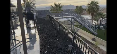 a view from the balcony of a building with a fence at Beautiful City Lights and Mountain Views in Menifee