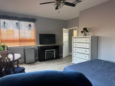 a bedroom with a bed and a television and a dresser at Beautiful City Lights and Mountain Views in Menifee