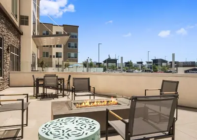 a patio with chairs and a fire pit on a balcony at Hampton Inn & Suites El Cajon San Diego in El Cajon