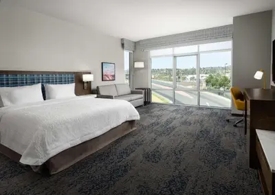 a hotel room with a bed and a large window at Hampton Inn & Suites El Cajon San Diego in El Cajon