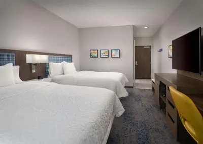 a hotel room with two beds and a flat screen tv at Hampton Inn & Suites El Cajon San Diego in El Cajon