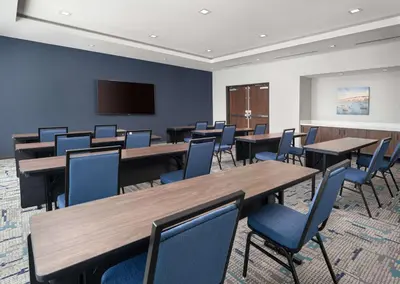 a conference room with tables and chairs and a flat screen tv at Hampton Inn & Suites El Cajon San Diego in El Cajon