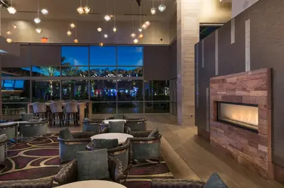 a lobby with a fireplace and tables and chairs at Viejas Casino & Willows Hotel in Alpine