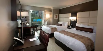 a hotel room with two beds and a desk at Viejas Casino & Willows Hotel in Alpine