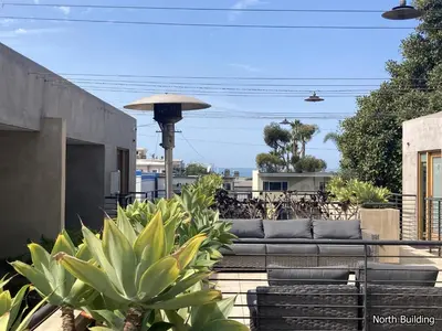 a patio with a couch and some plants at 14 West Laguna Beach in Laguna Beach