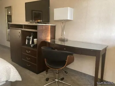 a desk with a lamp and a chair in a hotel room at 14 West Laguna Beach in Laguna Beach