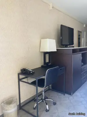 a desk with a lamp and a tv and a chair at 14 West Laguna Beach in Laguna Beach