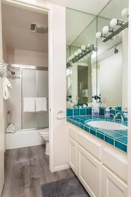 a bathroom with a tub and a toilet and a mirror at 3 Bedroom! - Complex is on the beach with huge pool in Oceanside
