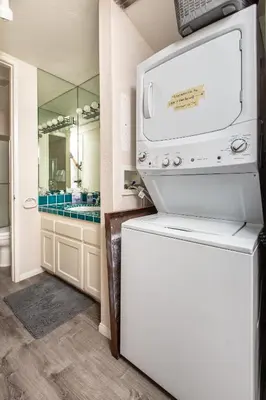 a kitchen with a white refrigerator and a mirror at 3 Bedroom! - Complex is on the beach with huge pool in Oceanside