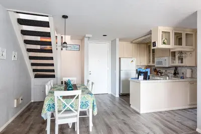 a kitchen and a dining room with a table and chairs at 3 Bedroom! - Complex is on the beach with huge pool in Oceanside