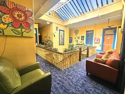 a living room with couches and chairs in a building at Gaslamp Hostel in San Diego