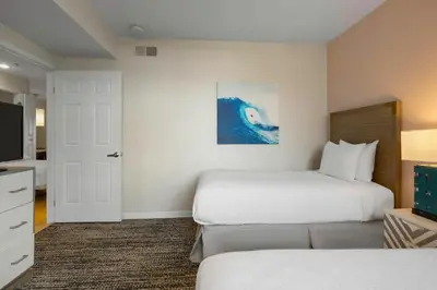 a hotel room with two beds and a television at Worldmark Oceanside Harbor in Oceanside
