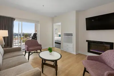 a living room with a couch and a fireplace at Worldmark Oceanside Harbor in Oceanside