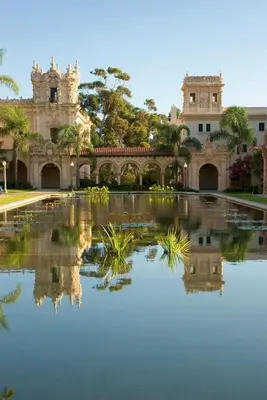 a building with a reflection in a pool of water at Hotel Marisol Coronado in San Diego