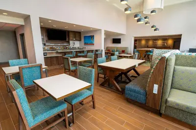 a restaurant with tables and chairs and a bar at Hampton Inn & Suites Imperial Beach San Diego, Ca in Imperial Beach