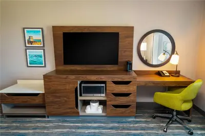 a room with a tv and a desk and a mirror at Hampton Inn & Suites Imperial Beach San Diego, Ca in Imperial Beach