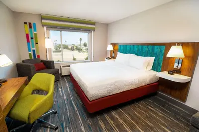 a hotel room with a bed and a desk and chair at Hampton Inn & Suites Imperial Beach San Diego, Ca in Imperial Beach