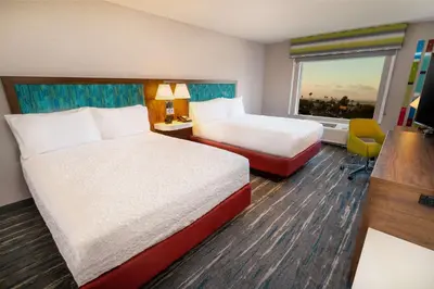 a hotel room with two beds and a window at Hampton Inn & Suites Imperial Beach San Diego, Ca in Imperial Beach