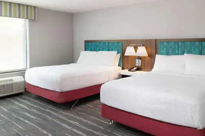 a hotel room with two beds and a window at Hampton Inn & Suites Imperial Beach San Diego, Ca in Imperial Beach