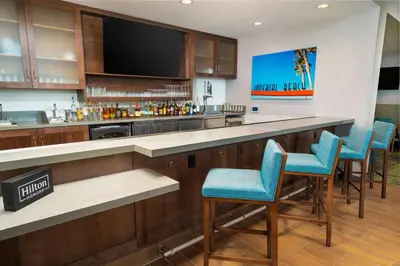 a bar with blue chairs in a hotel room at Hampton Inn & Suites Imperial Beach San Diego, Ca in Imperial Beach