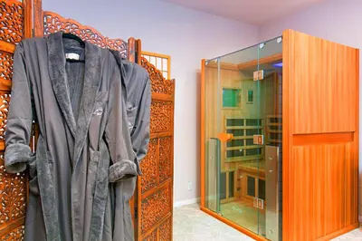 a robe is hanging in a room with a glass shower at Quiet Mind Mountain Lodge, Retreat & Spa in Julian