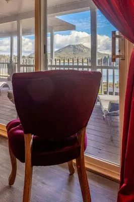 a chair in front of a window with a view at Quiet Mind Mountain Lodge, Retreat & Spa in Julian